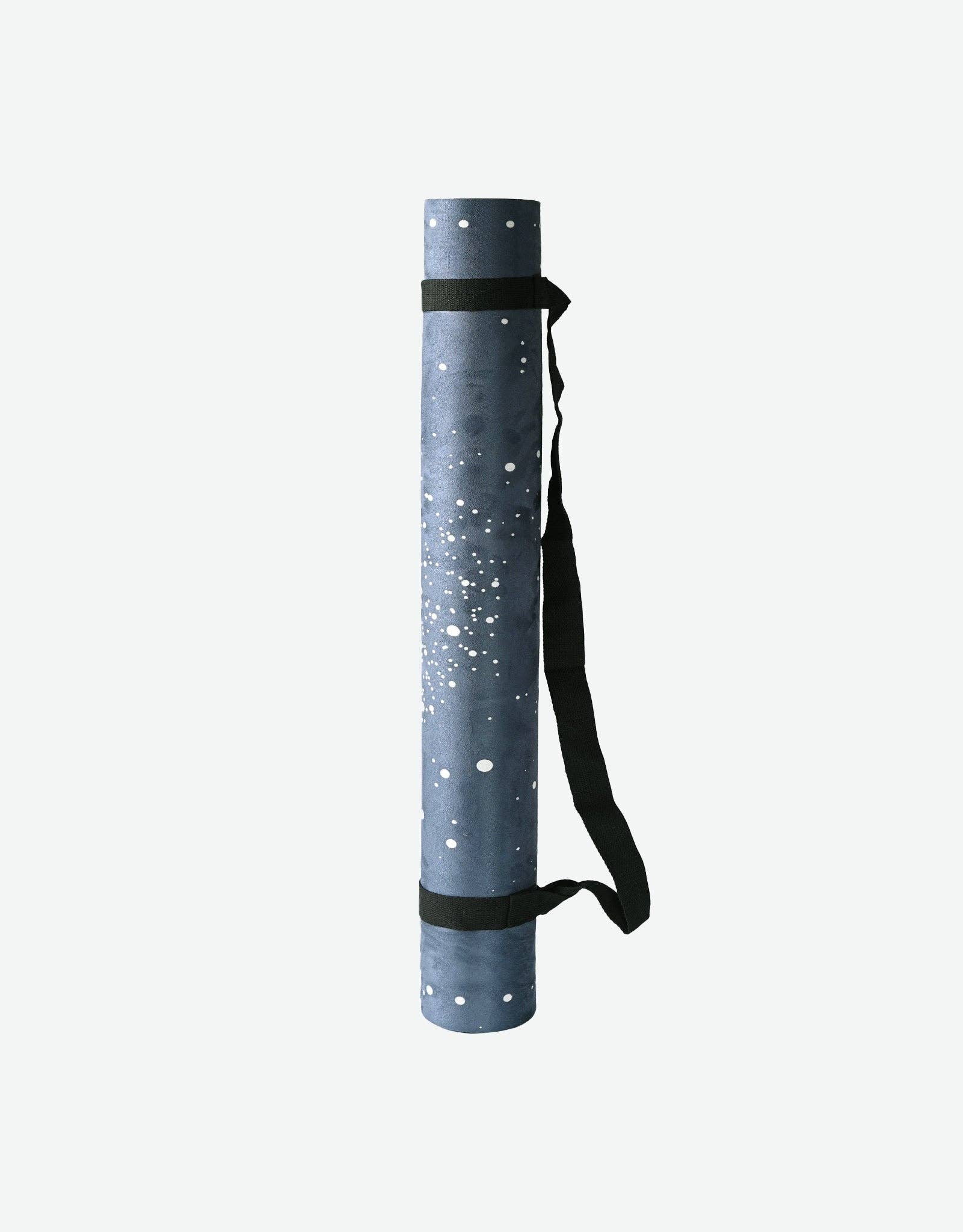 Yoga mat with a carrying strap on a white background
