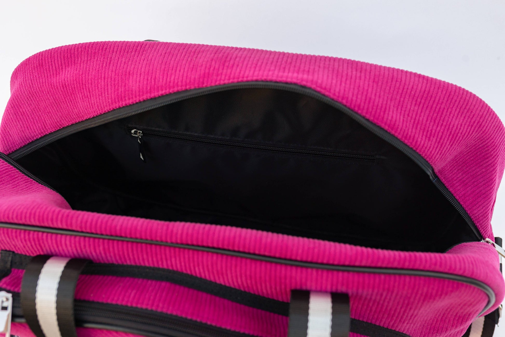 Close-up of a pink suitcase with a white background
