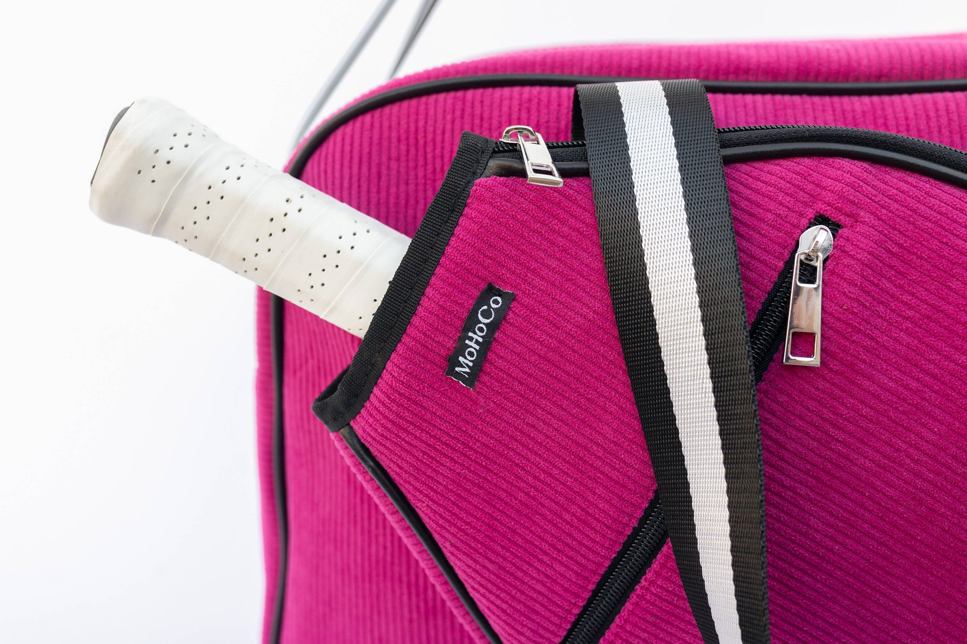 Pink suitcase with a black handle and visible brand logo on a white background